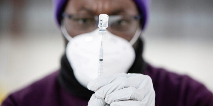 Safeway pharmacy manager Kel Fanny draws up a COVID-19 vaccine at a coronavirus disease (COVID-19) mass vaccination site at the Clark County Event Center at the Fairgrounds in Ridgefield, Washington, U.S. January 27, 2021. REUTERS/Alisha Jucevic