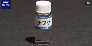 Small clear bottle with a white cap labeled ナフサ (naphtha) on a dark surface; NHK News watermark in corner.