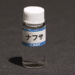 Small clear bottle with a white cap labeled ナフサ (naphtha) on a dark surface; NHK News watermark in corner.