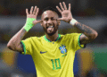 Neymar é convocado por Ancelotti e disputará sua quarta Copa do Mundo com o Brasil - ThingsOut Brazilian soccer player wearing a yellow Brazil jersey with number 10, hands to ears, tongue out in celebration.