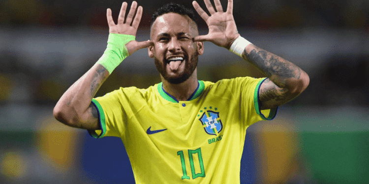 Neymar é convocado por Ancelotti e disputará sua quarta Copa do Mundo com o Brasil - ThingsOut Brazilian soccer player wearing a yellow Brazil jersey with number 10, hands to ears, tongue out in celebration.