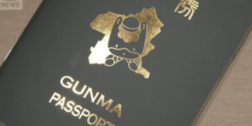 Dark passport cover with embossed gold Gunma Passport text and mascot emblem; ANN News watermark in top-left corner.