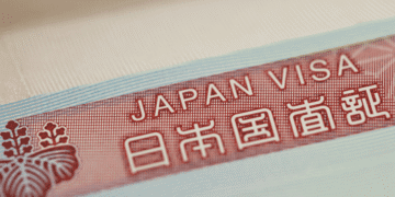 Close-up of a red Japan visa label with the text 'JAPAN VISA' and Japanese characters on a light blue border.