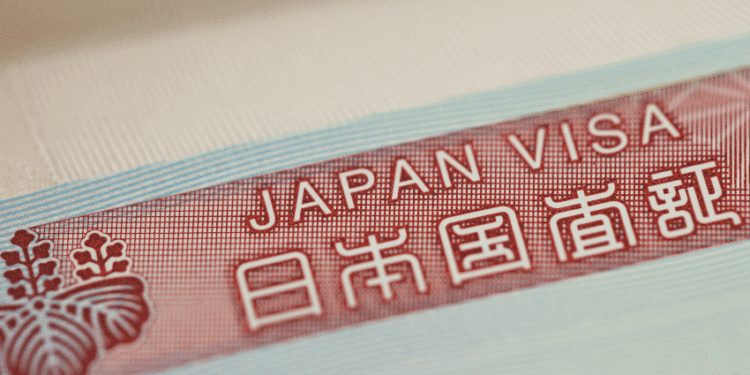 Close-up of a red Japan visa label with the text 'JAPAN VISA' and Japanese characters on a light blue border.