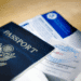 Novas restrições a estrangeiros podem prejudicar a imagem global do Japão - ThingsOut Blue US passport with embossed seal on a wooden table beside travel documents and tickets.
