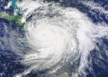 Satellite view of a large hurricane with a clear eye spiraling over the Caribbean Sea near Cuba, seen from space.