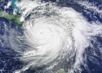 Satellite view of a large hurricane with a clear eye spiraling over the Caribbean Sea near Cuba, seen from space.