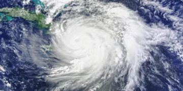 Satellite view of a large hurricane with a clear eye spiraling over the Caribbean Sea near Cuba, seen from space.