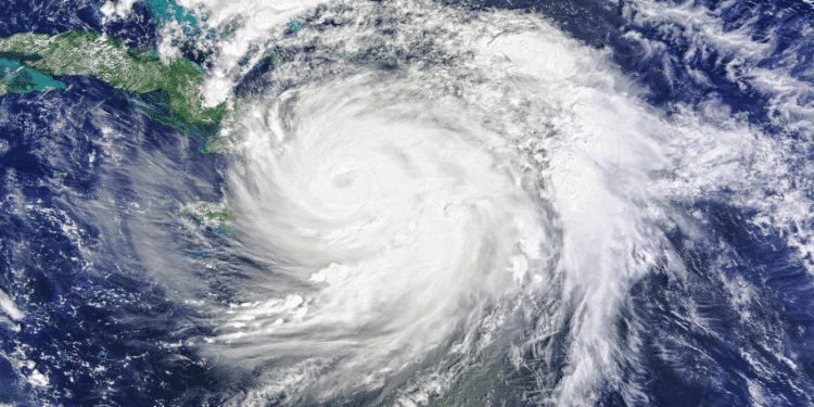 Satellite view of a large hurricane with a clear eye spiraling over the Caribbean Sea near Cuba, seen from space.