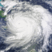 Satellite view of a large hurricane with a clear eye spiraling over the Caribbean Sea near Cuba, seen from space.