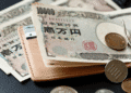Japanese yen banknotes and coins resting on a brown wallet, money and currency concept (10,000 yen notes)