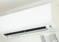 Japão prevê queda nas contas de luz e gás em agosto com reforço de subsídios - ThingsOut White wall-mounted air conditioner unit with its front panel closed and vent opening visible on the lower front edge.
