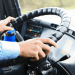 Oita acelera contratação de motoristas estrangeiros para enfrentar escassez no transporte - ThingsOut Close-up of hands gripping the steering wheel inside a truck cab.