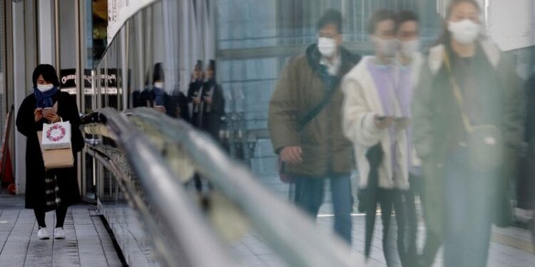 FILE PHOTO: Pedestrians walk on a street in Tokyo, Japan amid the COVID-19 outbreak