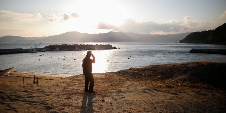 Sasaki who lost his family members in the March 11, 2011 earthquake and tsunami walks along the coast in Rikuzentakata